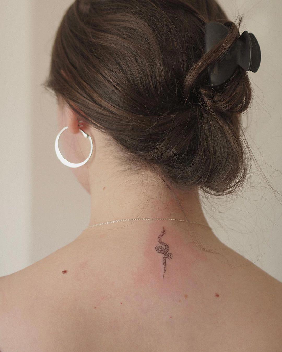 Tatuaje de serpiente pequeño en la nuca